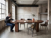 Transformer Table Eclipse dining table in a modern design, shown expanded for seating.