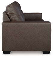 Ashley Furniture Barlin Mills sofa sleeper showing a side view with beige upholstery and a compact, functional design