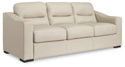 Ashley Furniture Treasure Trove sofa shown from an angled side view, featuring plush cushions and modern design.