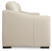 Ashley Furniture Treasure Trove sofa with beige upholstery and plush cushions, shown from a side angle.