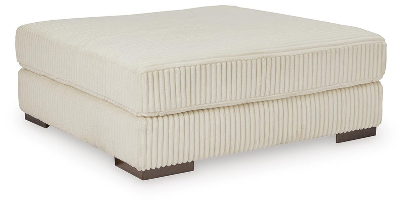 Ashley Furniture Lindyn living room set with sofa and loveseat, beige fabric upholstery, and modern design.