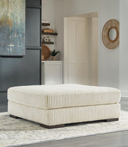 Ashley Furniture Lindyn living room set with sofa and armchair featuring neutral upholstery and modern design.