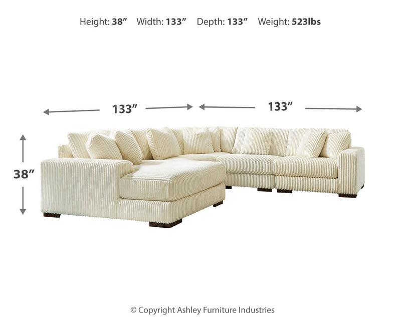 Ashley Furniture Lindyn living room set with sofa and loveseat, featuring neutral upholstery and modern design.