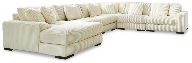 Ashley Furniture Lindyn living room set with sofa, loveseat, and chair in a modern fabric, arranged in a stylish living space.