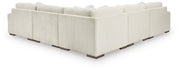 Ashley Furniture Lindyn living room set with sofa and armchair, upholstered in neutral fabric, shown from the back view.