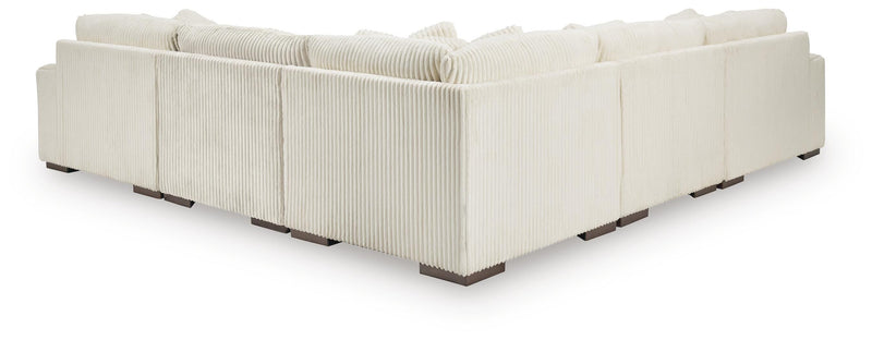 Ashley Furniture Lindyn living room set with sofa and armchair, upholstered in neutral fabric, shown from the back view.