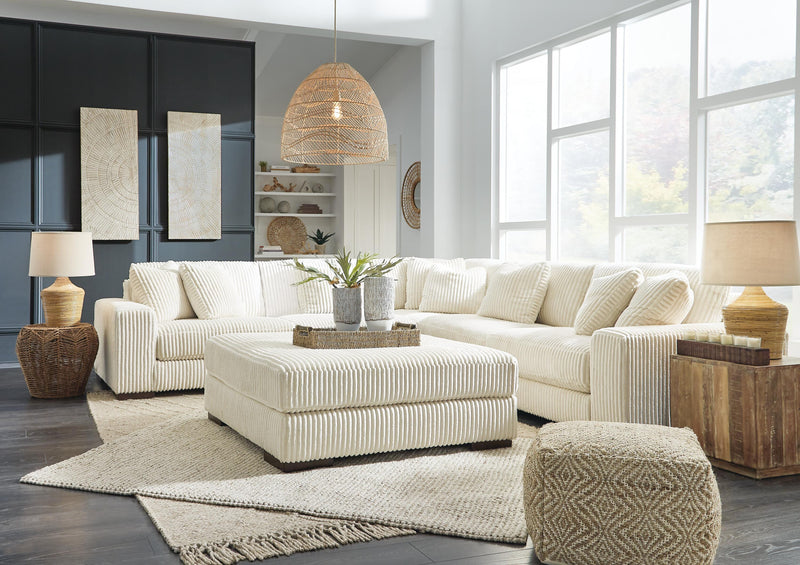 Ashley Furniture Lindyn living room set with sofa and loveseat featuring neutral upholstery and modern design.