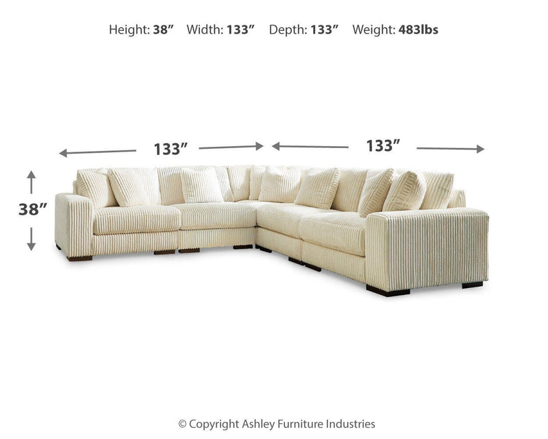 Ashley Furniture Lindyn living room set featuring a sofa and matching armchair with neutral fabric upholstery and modern design.