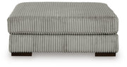 Ashley Furniture Lindyn living room set with sofa and armchair, featuring neutral upholstery and modern design.