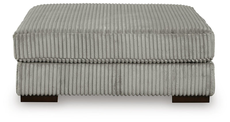 Ashley Furniture Lindyn living room set with sofa and armchair, featuring neutral upholstery and modern design.