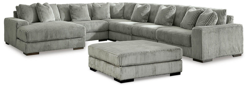 Ashley Furniture Lindyn living room set with sofa, loveseat, and armchair in a modern fabric design, arranged in a stylish living space.