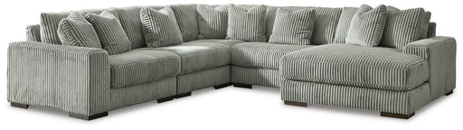 Ashley Furniture Lindyn living room set with plush sofa and armchair, featuring neutral fabric and modern design in a cozy living space.