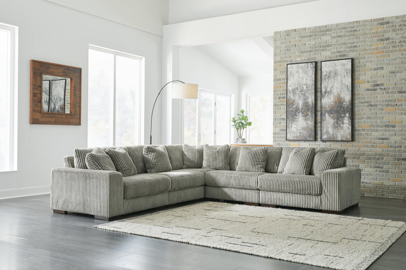 Ashley Furniture Lindyn living room set featuring a sofa, loveseat, and armchair with neutral fabric and modern design.
