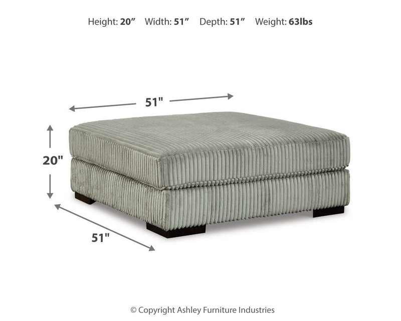 Ashley Furniture Lindyn living room set featuring a sofa, loveseat, and armchair with neutral fabric and modern design.