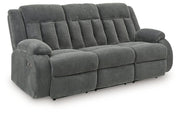 Ashley Furniture observation power reclining sofa with drop-down table, featuring plush cushions and built-in cup holders.