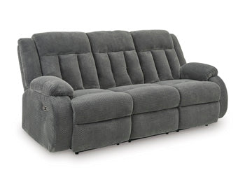 Ashley Furniture observation power reclining sofa with drop-down table, featuring plush cushions and built-in cup holders.