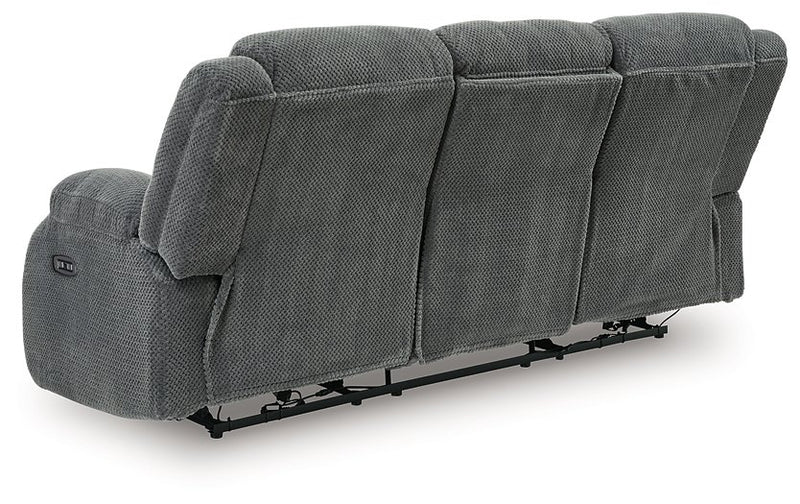 Ashley Furniture observation power reclining sofa with drop-down table, shown from the back with plush cushions and built-in features.