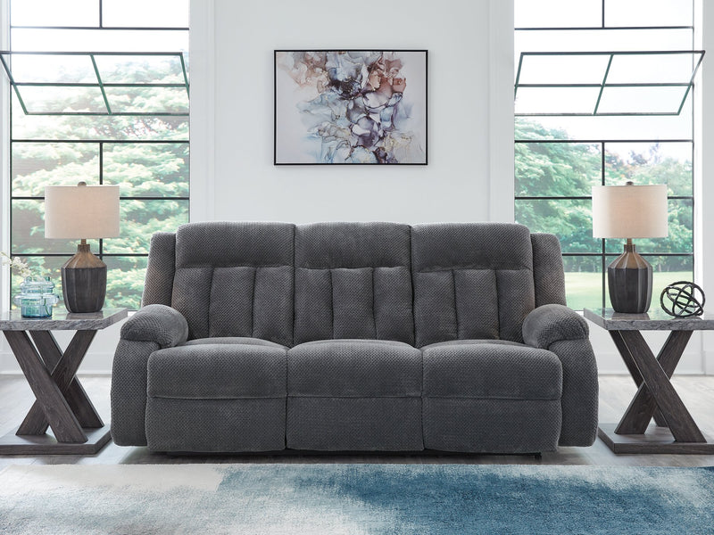 Ashley Furniture observation power reclining sofa with drop-down table, featuring plush cushions and built-in cup holders.