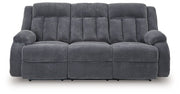 Ashley Furniture observation power reclining sofa with drop-down table, featuring plush cushions and built-in cup holders.