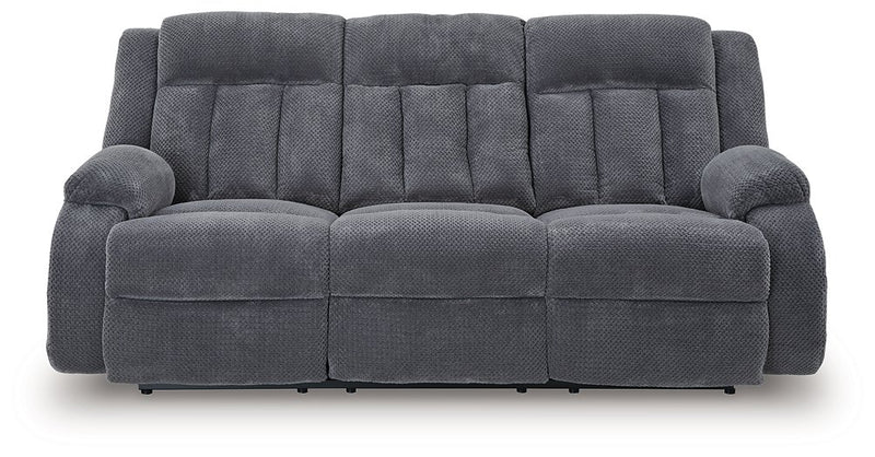 Ashley Furniture observation power reclining sofa with drop-down table, featuring plush cushions and built-in cup holders.