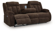 Ashley Furniture observation power reclining sofa with drop-down table, featuring plush cushions and built-in cup holders.