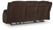 Ashley Furniture observation power reclining sofa with drop-down table, featuring plush cushions and built-in cup holders.