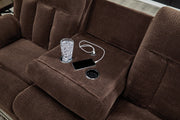 Ashley Furniture observation power reclining sofa with drop-down table, USB ports, in a modern living room setting.