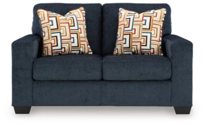 Ashley Furniture Aviemore loveseat with plush fabric and cushioned armrests, shown in a cozy living room setting.