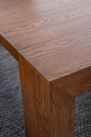 Transformer Table expandable dining table shown in its compact form; modern wood finish and sturdy legs