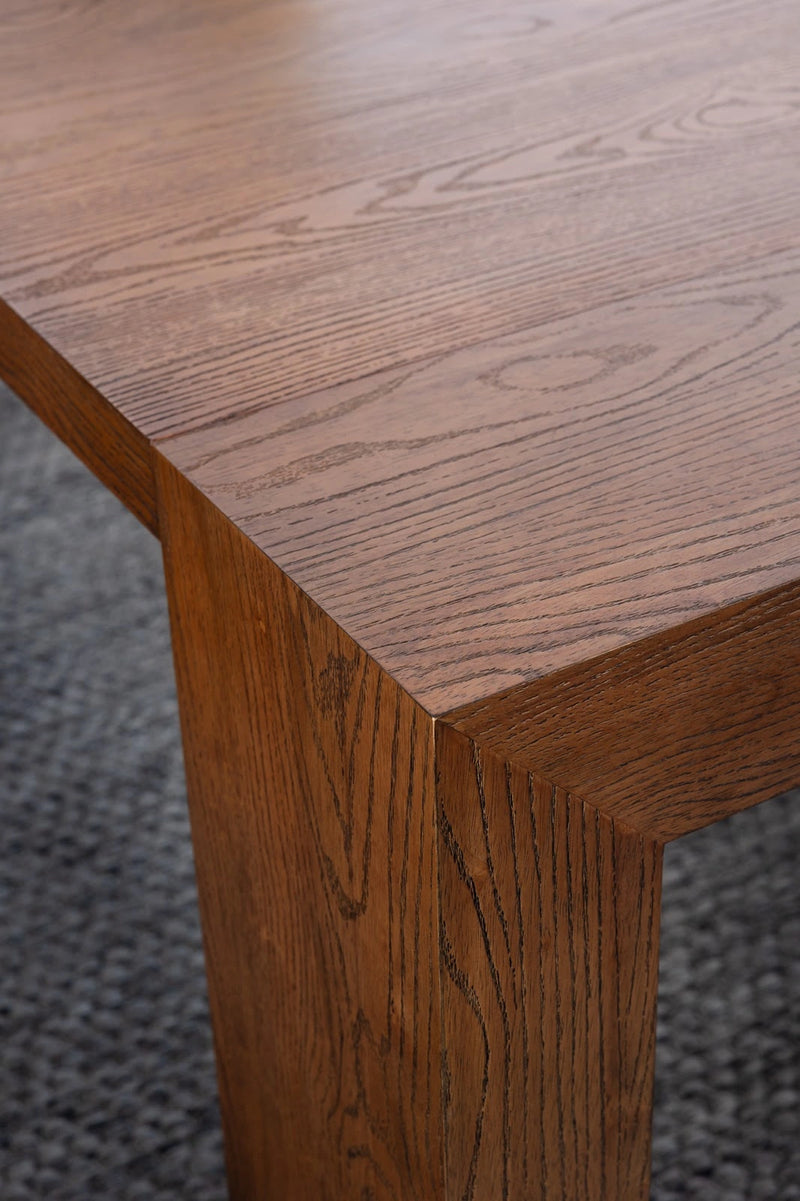 Transformer Table expandable dining table shown in its compact form; modern wood finish and sturdy legs