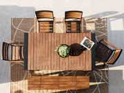 Transformer Table outdoor dining set with expandable table and matching benches on a patio