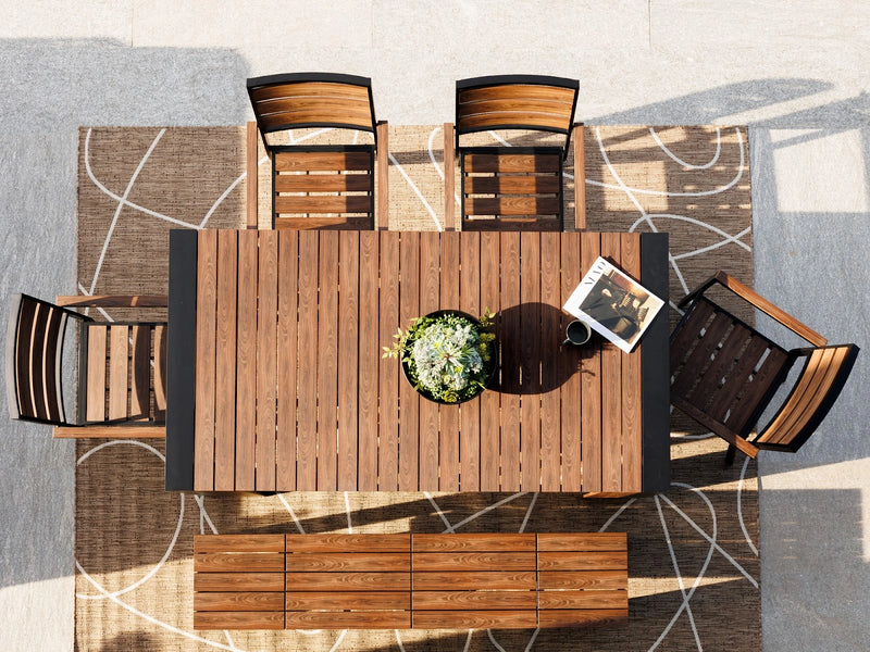 Transformer Table outdoor dining set with expandable table and matching benches on a patio