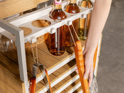 Transformer Table outdoor bar cart with black frame and wood serving surface, shown in a patio setting