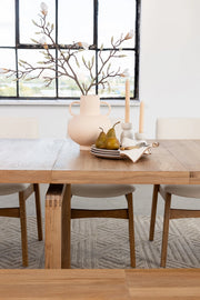 Transformer Table dining table shown in its compact configuration with a modern wood finish