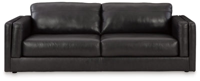 Ashley Furniture Amiata Sofa in beige fabric, showing plush cushions and contemporary design from a front head-on view.