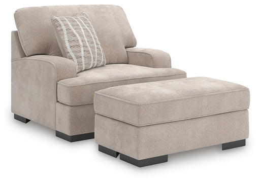 Ashley Furniture high profile living room chair and ottoman set with plush cushions and modern design.