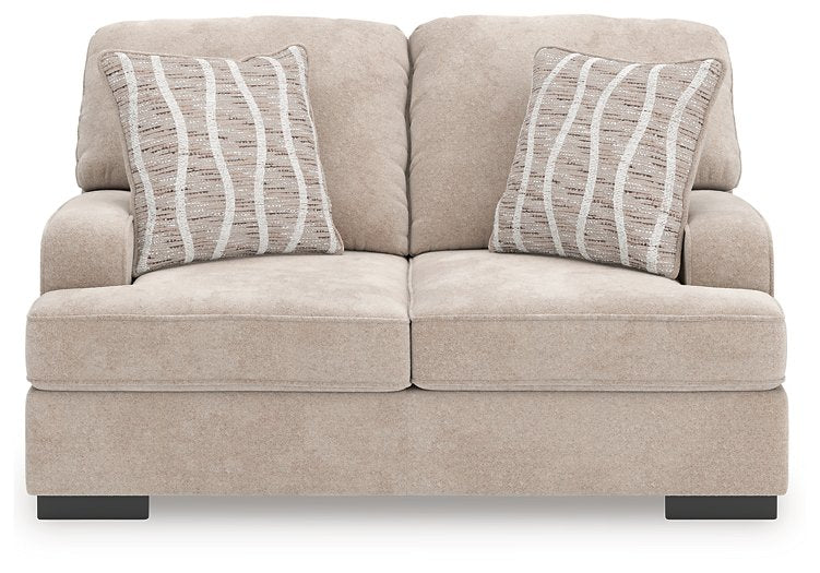 Ashley Furniture high profile loveseat with plush upholstery, shown from a front head-on view highlighting its stylish design.