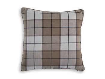 Ashley Furniture Godricton Pillow showing a plush, decorative pillow with textured fabric and neutral tones on a bed or sofa.