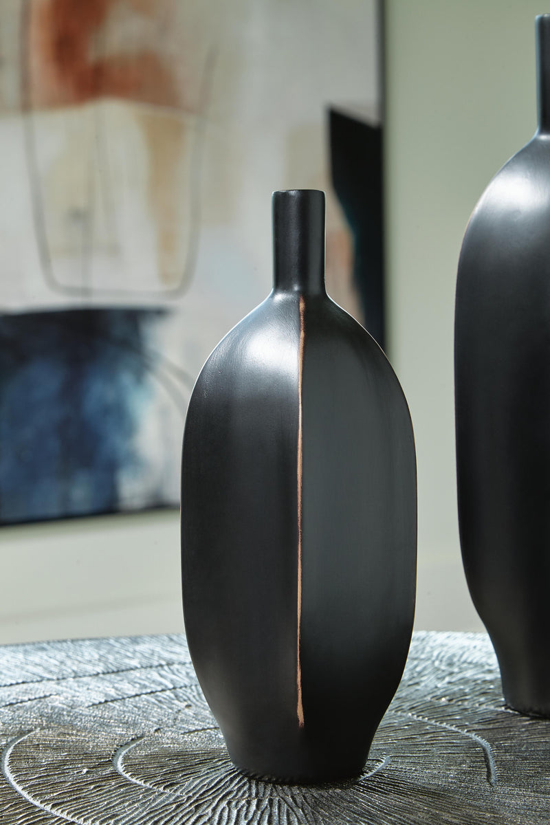 Ashley Furniture Rhaveney Vase showing a tall, elegant ceramic vase with a smooth finish and subtle decorative details.