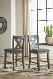 Ashley Furniture Caitbrook counter height upholstered bar stool with cushioned seat and dark wooden legs.