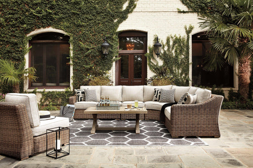 Ashley Furniture Beachcroft outdoor seating set with cushioned chairs and a matching table, ideal for patio relaxation.