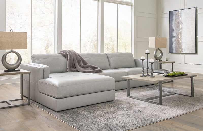Ashley Furniture Amiata sectional with chaise, showing a modern fabric sofa with a spacious chaise lounge in a stylish living room.
