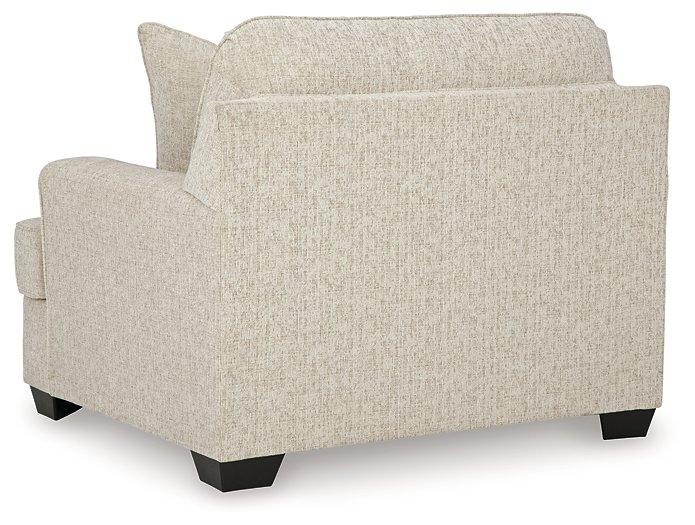 Ashley Furniture Heartcort living room set with sofa, loveseat, and armchair in neutral fabric, arranged in a modern living space.