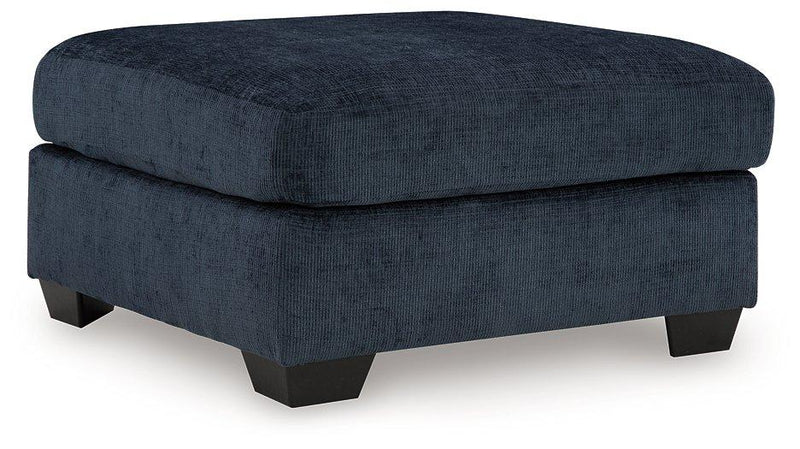 Ashley Furniture Aviemore oversized accent ottoman with plush fabric and sturdy wooden legs, ideal for living room decor.