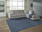 Ashley Furniture Altari living room set with sofa and armchair, featuring neutral fabric upholstery and modern design.