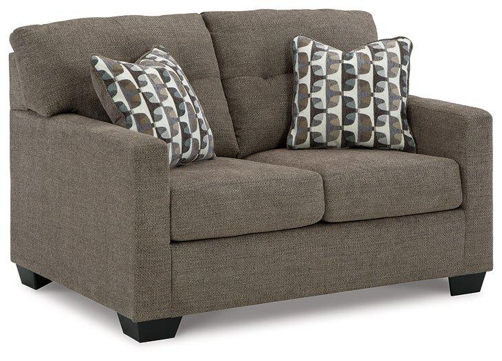 Ashley Furniture Mahoney living room set featuring a sofa and armchair with neutral upholstery and wooden accents.