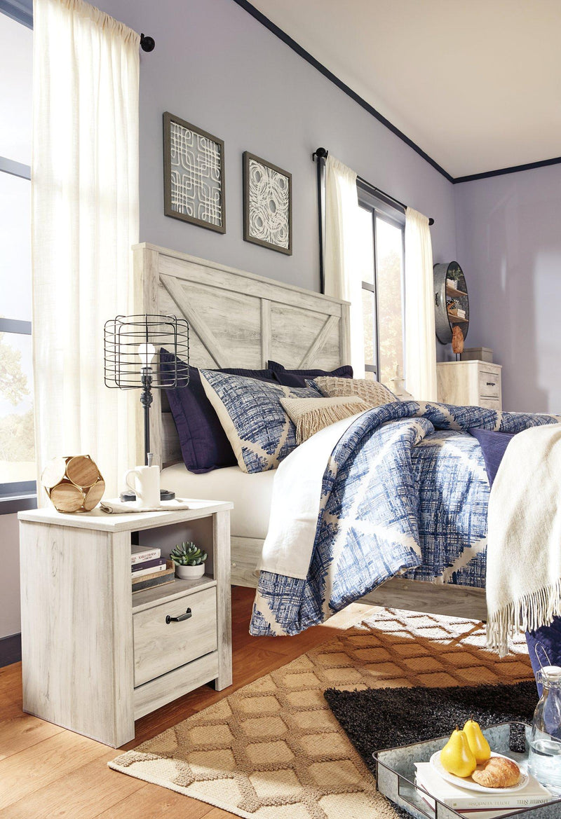 Ashley Furniture Bellaby Crossbuck Bed with a sturdy wooden frame and crossbuck headboard in a classic design.