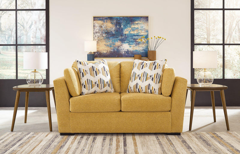 Ashley Furniture Keerwick living room set with sofa and loveseat, featuring neutral upholstery and modern design.