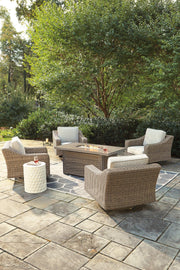 Beachcroft outdoor fire pit table with four Ashley Furniture Nuvella swivel lounge chairs in a stylish patio setting.