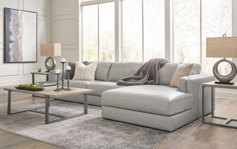 Ashley Furniture Amiata sectional with chaise showing plush fabric, modern design, and spacious seating in a contemporary living room setting.